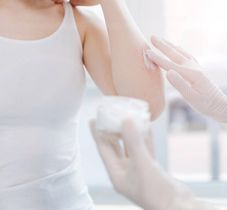 Treating skin disease. Caring helpful female dermatologist working in the hospital and treating patient while putting hypoallergenic cream on patient skin (Treating skin disease. Caring helpful female dermatologist working in the hospital and treating SSUCv3H4sIAAAAAAAEAJ1W0Y6sKBB932T/YeLzmAAKwv7KZh8QsSWtYgB7bmcy/76l3X0Hwdy92aduygJOnTpV1Oeff7y9Fa30RhV/vX1uK1ibcVx9cDIYO4MZvT/tujPBOiPHzbjZvvYvhQ8yrF776AhMKtfDunrtlaOc7rGhNRcfrLougw02/qDkfP6hc1pOPphJx9YevEYjY9NifoSjwc4djQ1+WEPQbr8H7FhE0SgZ9AXCPMTzoujvx